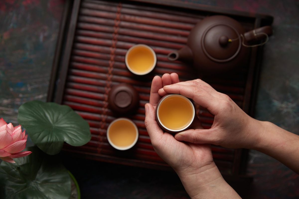 Hands cradling a warm cup of tea